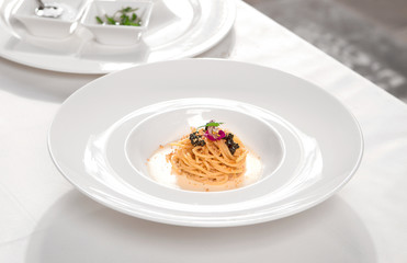 Italian pasta with black caviar and cream