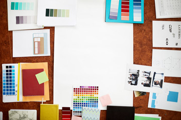 Top view background of creative design supplies lying on wooden table with white paper, copy space