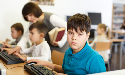 Tween boy during lesson in computer room