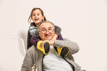 Little granddaughter hugging her grandfather