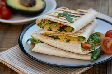 Healthy avocado and vegetables burrito, wraps, rolles. Healthy breakfast or snack. Avocado sandwich.