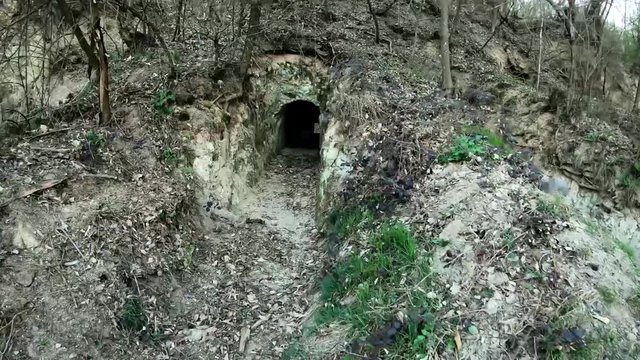 An ancient cellar resembling a hobbit house. The path to the small door in the mountain.