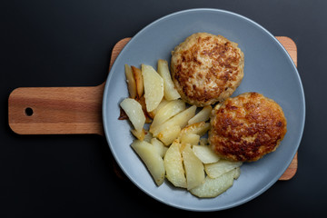 Cutlet with potatoes on the plate