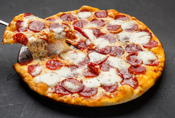 Hot pepperoni pizza with melting cheese on table