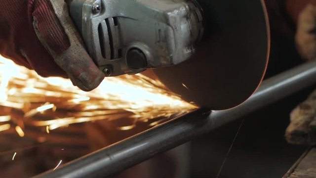 Close up picture of worker with cut grinder, men work with metal		