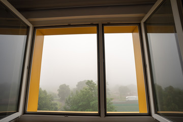 Fototapeta na wymiar View from the open window in foggy weather