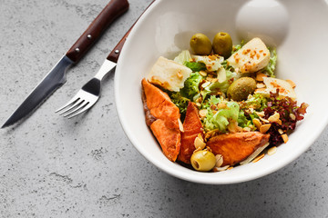Fresh salad with salmon, olives and cheese