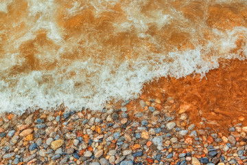Texture of white sand with crystal clear water. Sea wave on the beach.
