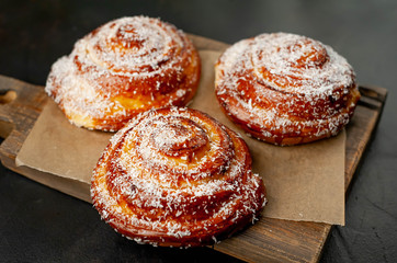 buns with pineapple filling on a cutting board on a background of concrete,Kanelbule - swedish dessert