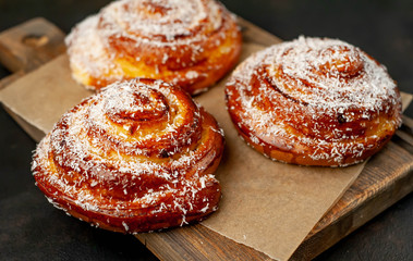 buns with pineapple filling on a cutting board on a background of concrete,Kanelbule - swedish dessert