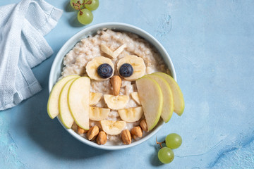 Kids breakfast porridge with fruits and nuts look like a owl
