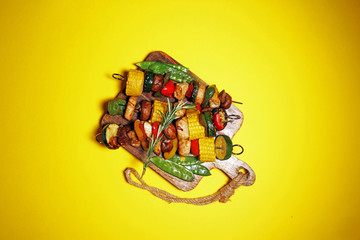 Assorted delicious grilled meat and skewer with vegetable on rustic table