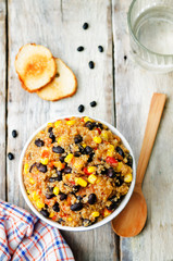 black beans, quinoa and corn chili on a wood background