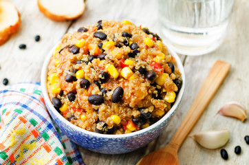 black beans, quinoa and corn chili on a wood background