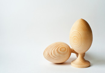 Decorative two wooden eggs  on white background,  Easter design, copy space