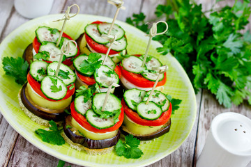 Vegetable appetizer towers of eggplant, pepper, tomato, cucumber on toasted bread with skewers