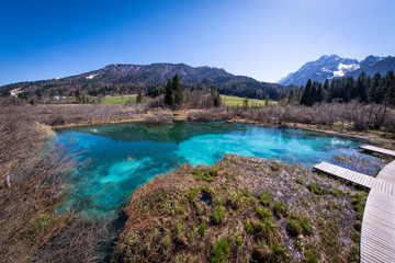 Naklejka na ściany i meble Lake Zelenci with observation trail and ponce mountains in Slovenia