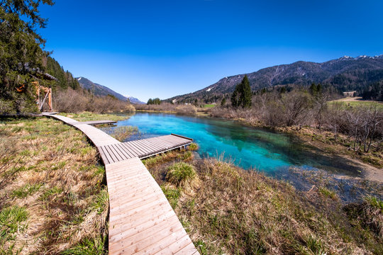 Lake Zelenci with observation trail footbridge in nature reserve Slovenia