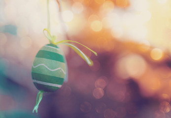 Hanging Easter eggs on tree with soft focus bokeh and color toned. Spring easter concept background.