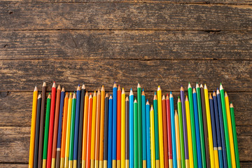 Colorful pens and pencils on the wooden desk