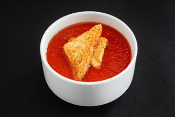 tomato cream soup on the black background