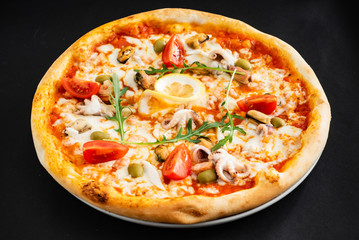 seafood pizza on the black background
