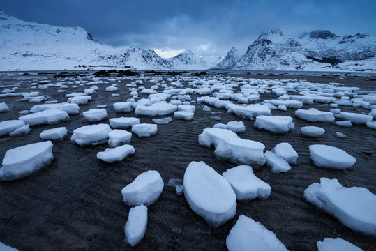 Snow patters on sand in Flakstadpollen at low tide, Flakstad&oslash;y, Lofoten Islands, Norway