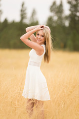 Fototapeta na wymiar Beautiful teen posing in golden field