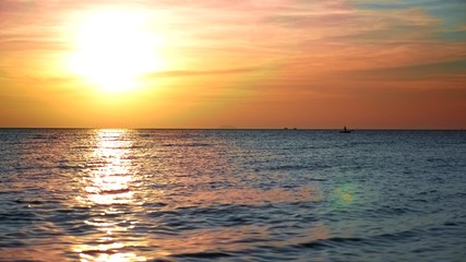 beautiful sunset on the sea with boat silhouettes on the horizon