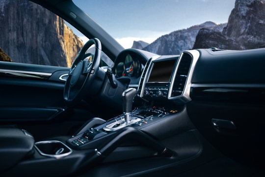 Expensive car interior with stearing wheel, multimedia and gearbox handle