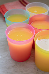 Orange Juice in colorful glasses.