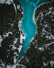 Aerial view at winter frozen Pragser Wildsee/Lago di Braies in Italian Alps. Blue lake.