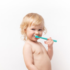 little cute curly baby smiles and cleans teeth on white background