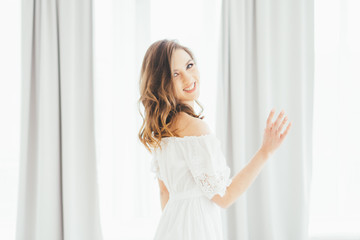 Girl at the curtains.  The girl at the window. Gentle image of a girl.