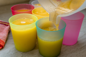 Orange Juice in colorful glasses.