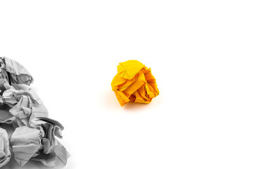 Concept or illustration of leadership, management or loneliness and uniqueness with the help of crumpled pieces of paper of orange and gray color on a white background.