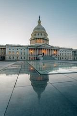 Fototapeta premium The United States Capitol reflecting in glass, in Washington, DC