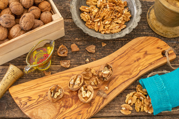 Many walnuts on the rustic table and in the shopping bag