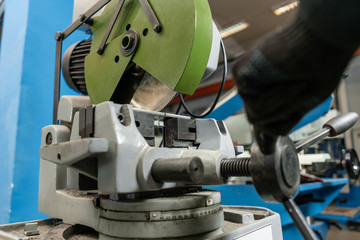 Circular saw machine. Cutting a metal and steel with with sharp, circular blade in workshop interior. Tool store or exposition stand.