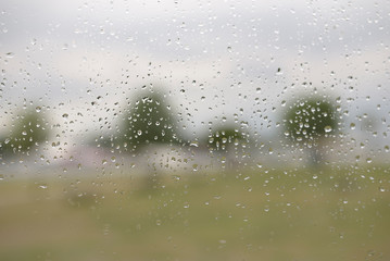 Natural beauty of raindrops on windscreen on gray background