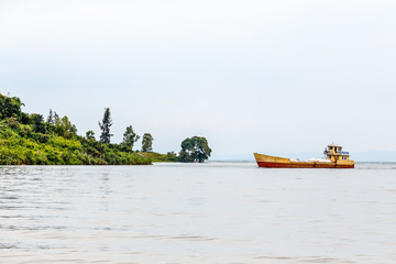 Fototapeta na wymiar Cargo ship anchored at the shore, Kivu lake, Rwanda