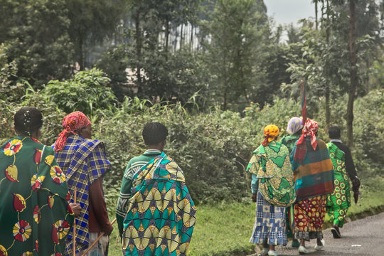 Group of rural Rwandan women in colorful traditionals clothes walking along the road, Kigali, Rwanda