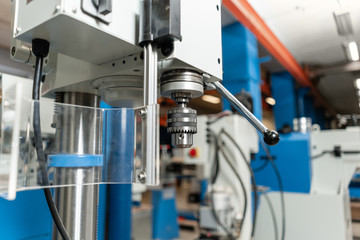 New Industrial Iron drill in workshop interior. Tool store or exposition stand.