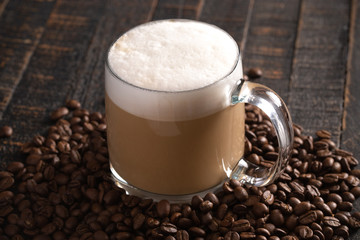 Cafe Latte Coffee in a Clear Glass Mug in a Dark Environment