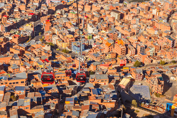 Cable cars or funicular system over orange roofs and buildings of the Bolivian capital, La Paz, Bolivia © vadim.nefedov