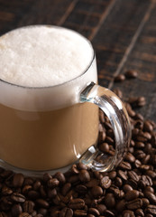 Cafe Latte Coffee in a Clear Glass Mug in a Dark Environment