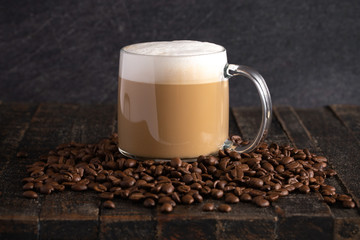 Cafe Latte Coffee in a Clear Glass Mug in a Dark Environment