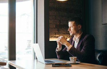 Young handsome businessman conducting negotiations with investors. Electronic business. Alternative payment services. Management of the projects on freelance. Cryptocurrency. Blockchain. Trader.