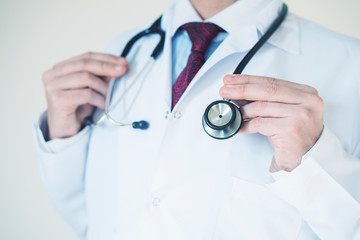 Bright close up of male doctor with stethoscope. Medical concept