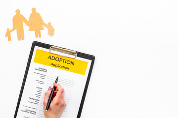 Children care with adoption application and family figure on white background top view space for...